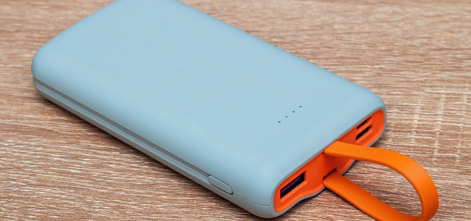 A power bank sitting on a wooden surface