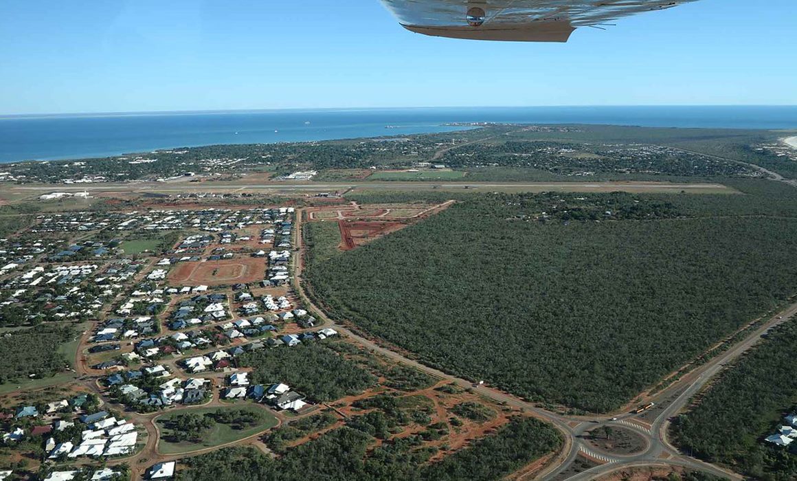 A Cessna 172S flying over a river in North Queensland