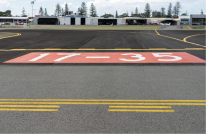 A known runway incursion hotspot at Gold Coast airport. The numbers "17-35" are painted on the runway in white text over a red background, with the markings for a holding position painted in front of them
