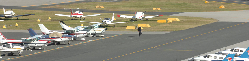 The apron at Jandakot aerodrome, with a bunch of planes parked in rows