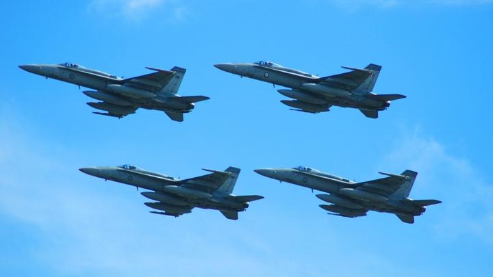 Military aircraft flying in formation