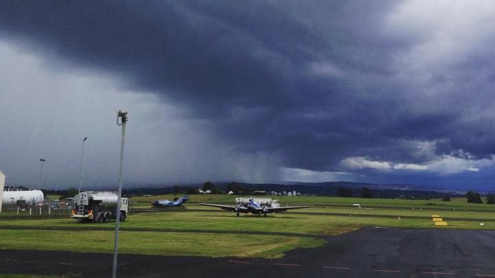 View of aerodrome with clouds and looming storm