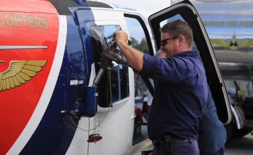 A man refueling a helicopter