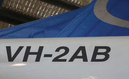 A photo of the tail of an aircraft, with the registration number VH-2AB