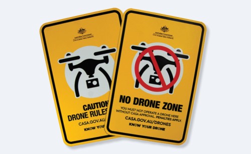 The two metal Know Your Drone safety signs sitting partly overlapping each other on a white background