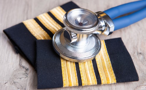A stethoscope resting on top of a pair of pilot's epaulets