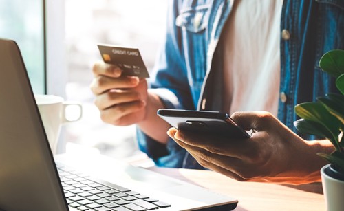 A woman shopping online using her laptop