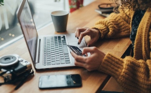 A woman shopping online using her laptop