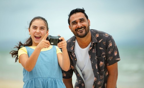 A man and his daughter flying a drone together