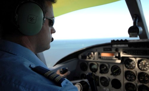 A male pilot in the cockpit 