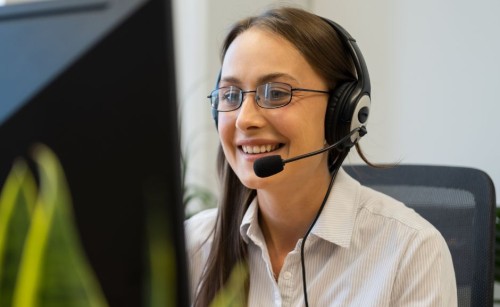 Person with a headset on at a desktop PC
