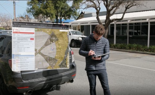 A drone pilot consulting a map of airspace on his tablet