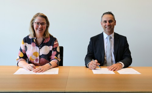 Pip Spence, CASA CEO and Director of Aviation Safety, and Enrico Palermo, Head of the Australian Space Agency, smile as they sign the Memorandum of Understanding