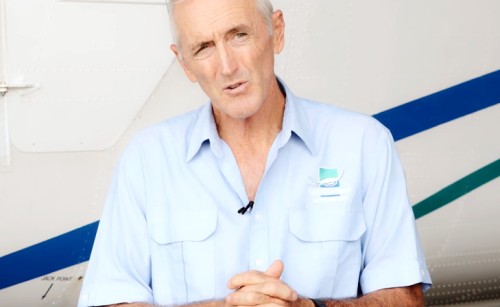 An airline managing director being interviewed in front of a plane