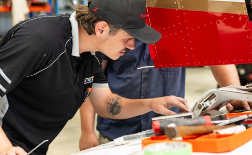 A young maintenance engineer examines an aircraft component