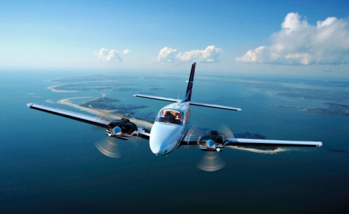 A Beechcraft twin-engine aeroplane flying through the sky