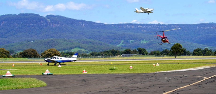 Image of various aircraft landing and taking off on a runway