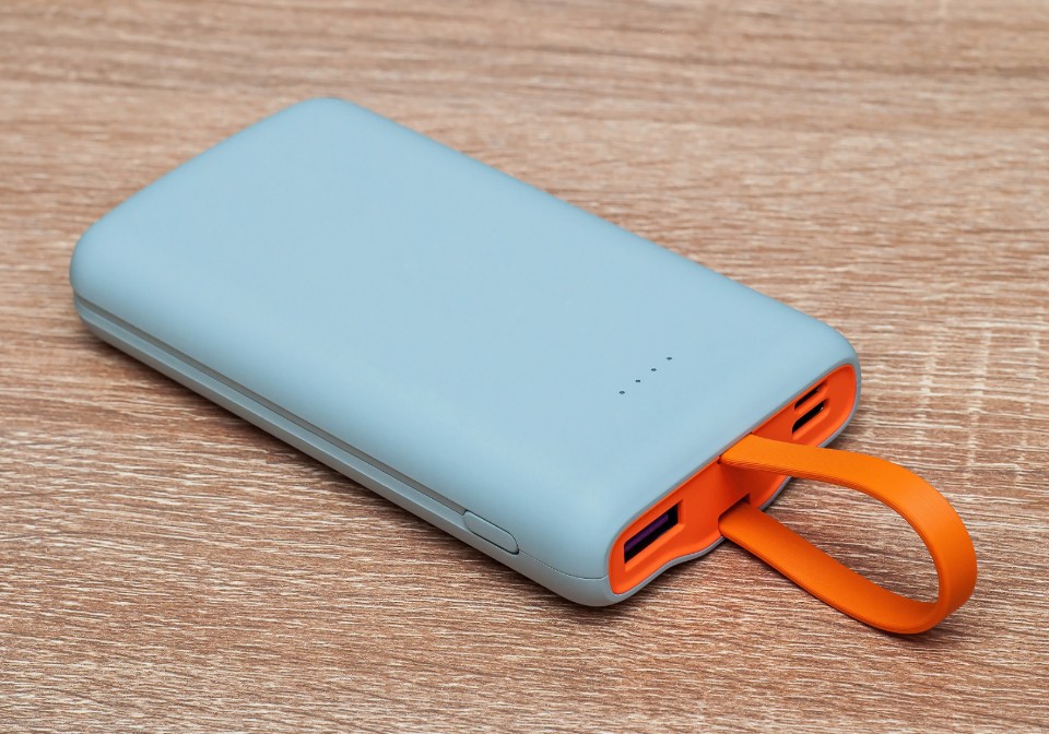 A power bank sitting on a wooden surface