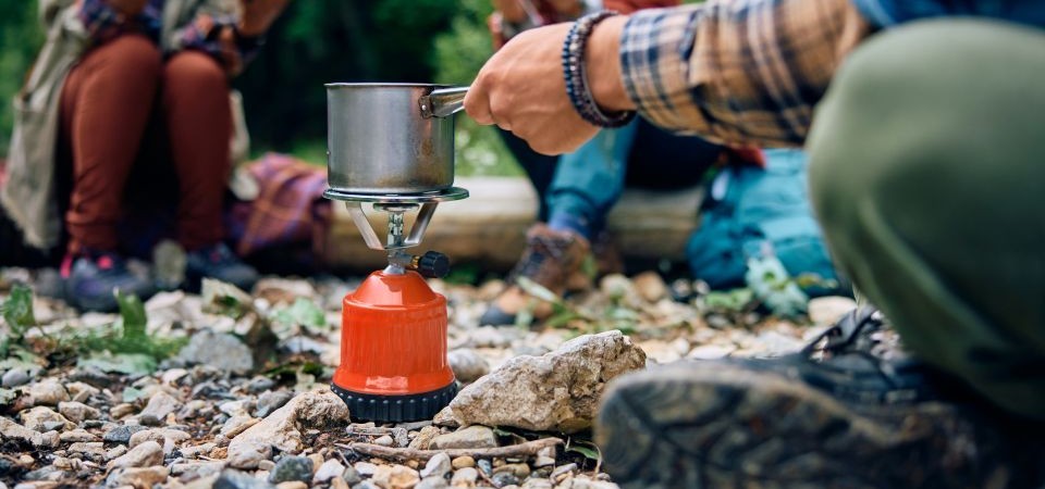 Campers using a portable gas stove