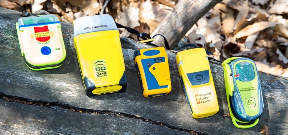 Five locator beacons sitting in a line on a rock