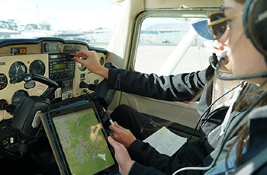 A pair of pilots checking their electronic flight bag