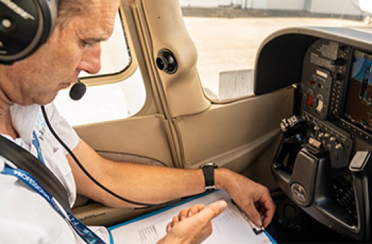 A pilot doing preflight checklists