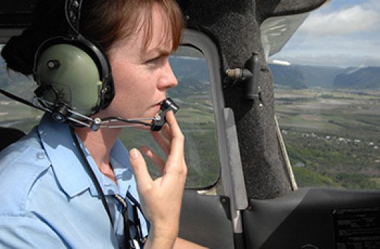 A pilot talking on their radio headset
