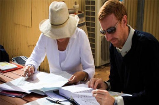 A male pilot and female pilot planning a flight together