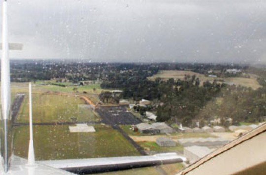 The view from a plane flying into Kowanyama Aerodrome in the rain