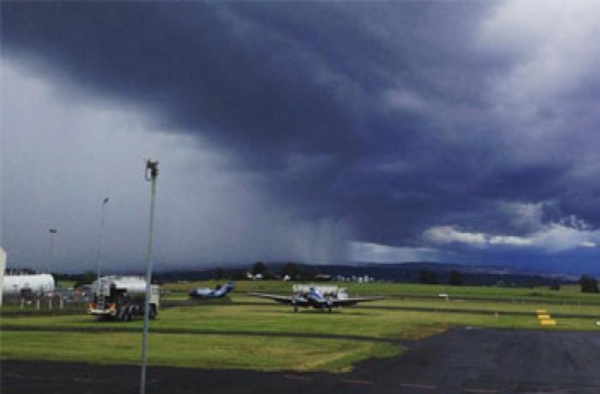 An outback aerodrome with dark clouds covering the sky