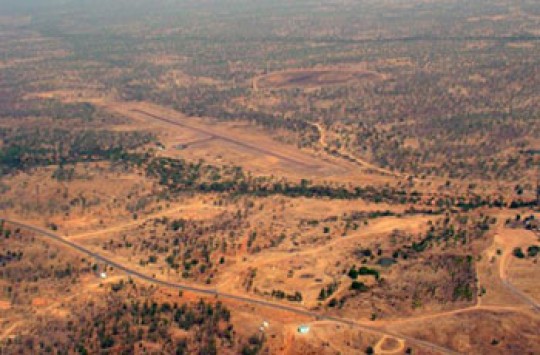 A small airport runway in a dusty field in the Outback.