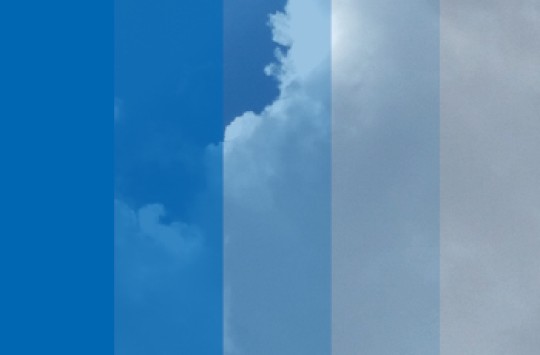 A picture of a cloud beneath steadily-less-transparent strips of blue color