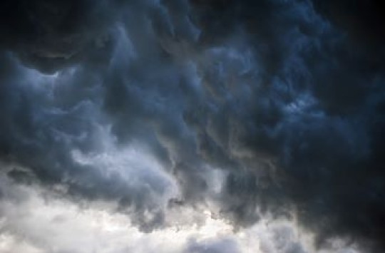 A dark, wispy cloud hangs in the sky