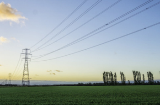 Image of a wire tower in a grass field