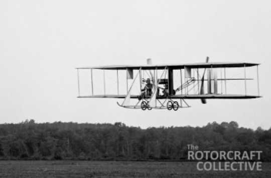 Black and white image of a biplane preparing to land