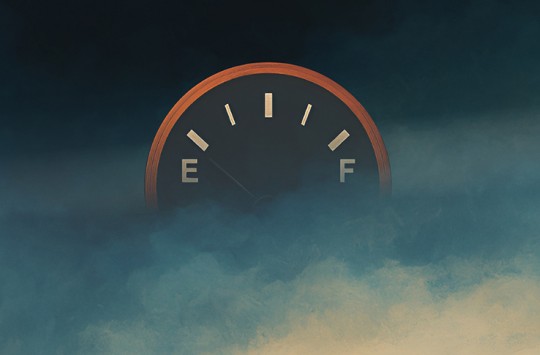 A fuel gauge floats in the clouds, its needle pointing towards empty