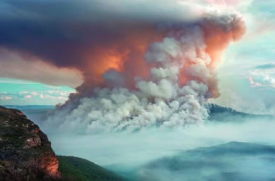 A towering cloud of smoke, glowing red from the inside