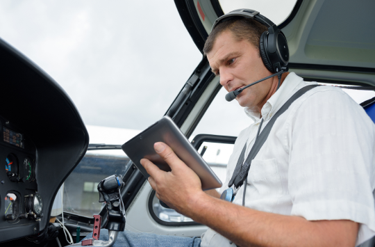 A pilot consulting their electronic flight bag