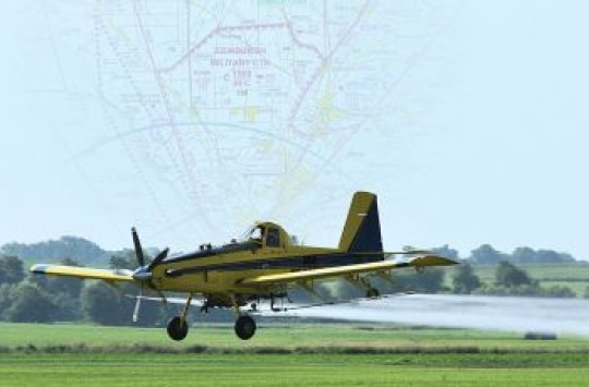 An aeroplane spraying a field, with an airspace map superimposed over the sky behind it