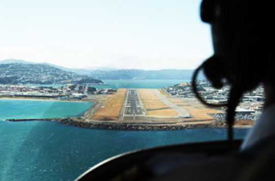 A view of a runway from the cockpit of an aeroplane coming in for landing