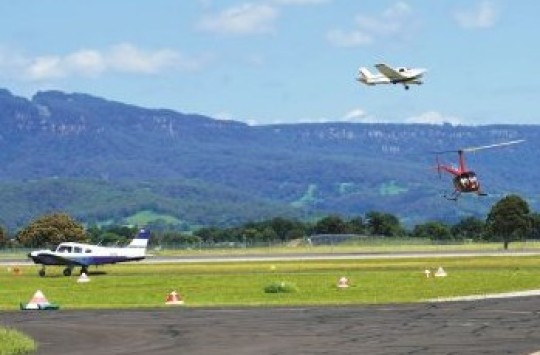 Helicopters and aeroplanes flying around an aerodrome