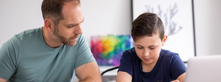 Adult helping child with drone classroom resources