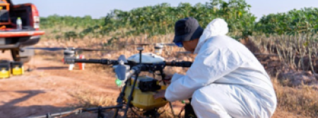 A farmer looking at a drone