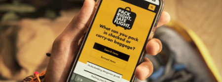 image of a person holding a mobile with Pack right. Safe flight app.