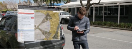 A man is looking at a map of airspace on his tablet