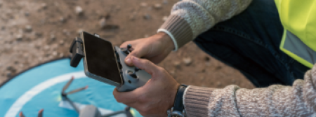 A persons' hands holding a drone remote control