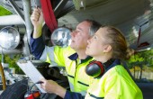 Two maintenance engineers inspecting an aircraft's landing gear