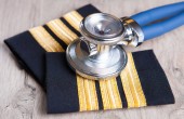 A stethoscope resting on top of a pair of pilot's epaulets