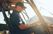 A pilot sitting in the cockpit of a helicopter