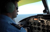 A male pilot in the cockpit 